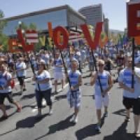In this June 8, 2014, photo, American Express workers carry giant, cutout letters that spelled, “Love=Love,” the theme of the of the gay pride parade, in Salt Lake City. ( Rick Bowmer / AP Photo )