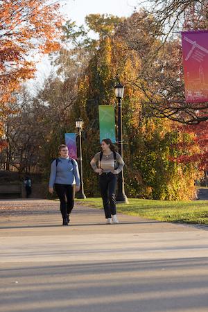 FGSS students walk in front of FGSS 50th anniversary banner