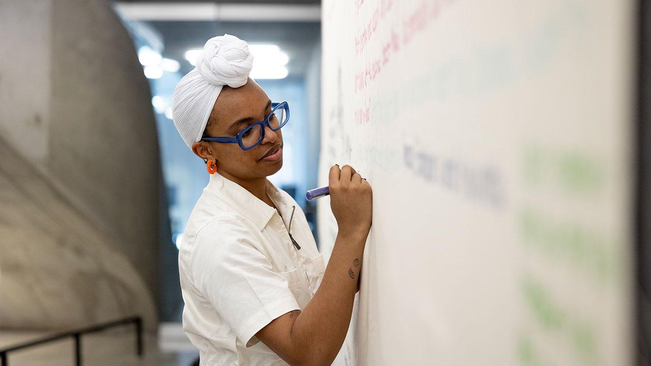 Student writing on white board