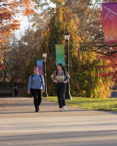 FGSS students walk in front of FGSS 50th anniversary banner